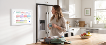 DailyHelp digital family wall calendar mounted in a bright family kitchen